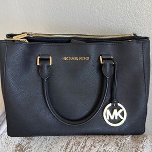 Michael Kors black and gold purse lots of pockets.